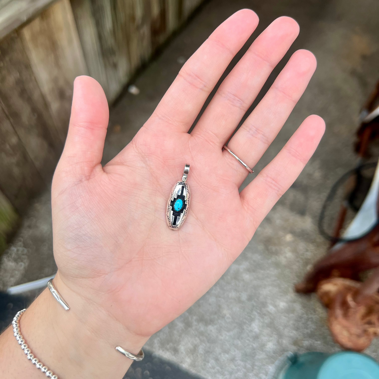 The Wynonna Genuine Turquoise Oval Aztec Shadowbox Sterling Silver Pendant