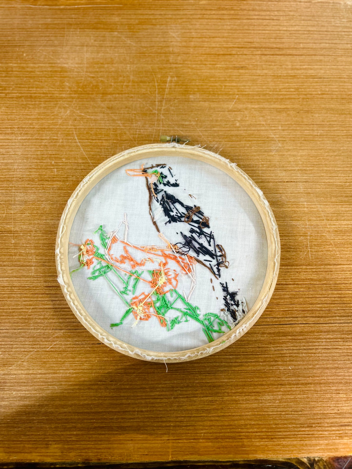 Embroidery Hoop With Hand-Stitched Bird Perched on Floral Banner