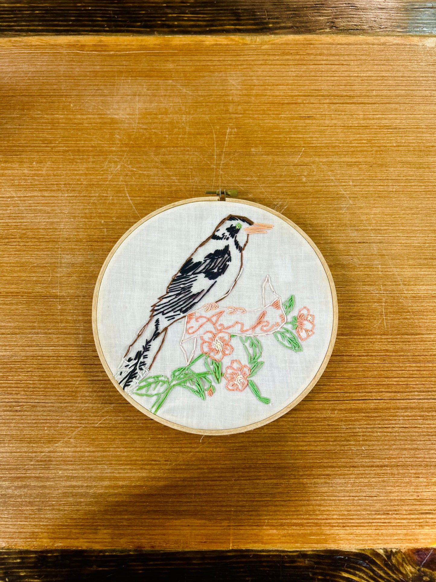 Embroidery Hoop With Hand-Stitched Bird Perched on Floral Banner